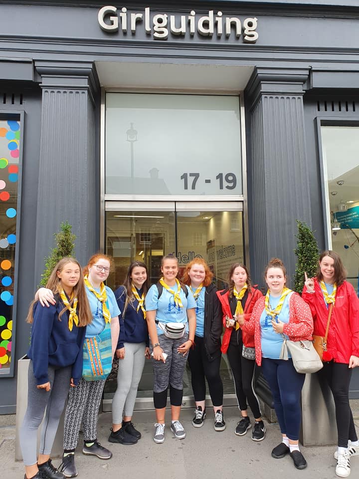 A group of Guides outside the entrance to girlguiding UK