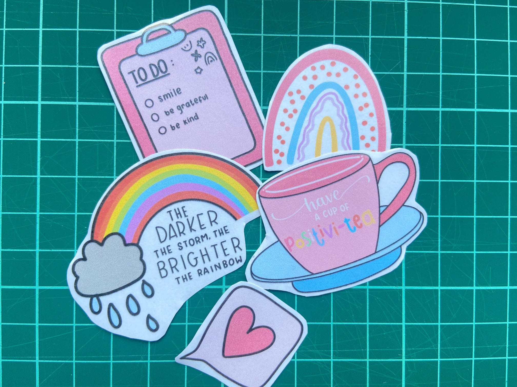 A set of 5 colourful stickers including a rainbow, a checklist and a cup of coffee