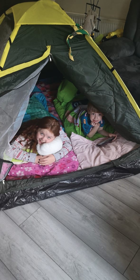 Two Members of St Francis in their tent set up indoors